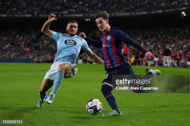 Oscar of Celta Vigo battles for possession with Gavi of FC Barcelona during the LaLiga Santander match between FC Barcelona and RC Celta at Spotify...