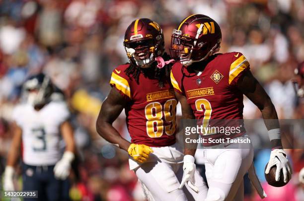 Dyami Brown of the Washington Commanders and Cam Sims of the Washington Commanders celebrate after Brown's touchdown during the third quarter against...