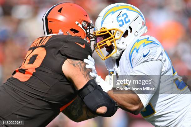 Khalil Mack of the Los Angeles Chargers defends against Jack Conklin of the Cleveland Browns during the second half at FirstEnergy Stadium on October...