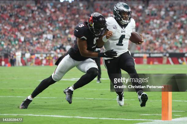Isaiah Simmons of the Arizona Cardinals tackles Jalen Hurts of the Philadelphia Eagles during the second quarter at State Farm Stadium on October 09,...