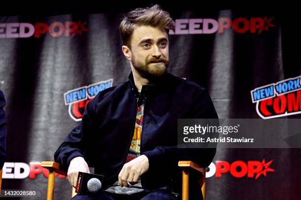 Daniel Radcliffe speaks onstage at Let's Get WEIRD panel during New York Comic Con 2022 on October 09, 2022 in New York City.