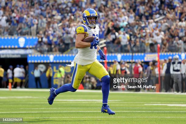 Cooper Kupp of the Los Angeles Rams runs for a touchdown after catching a pass against the Dallas Cowboys during the second quarter at SoFi Stadium...