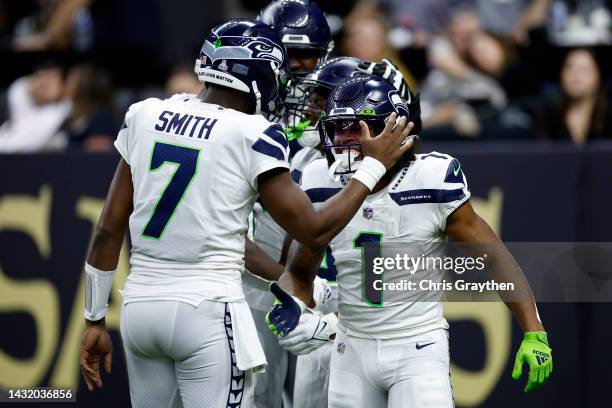 Geno Smith of the Seattle Seahawks reacts after a touchdown against the New Orleans Saints at Caesars Superdome on October 09, 2022 in New Orleans,...