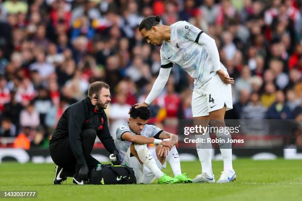 Virgil Van Dijk consoles team-mate Luis Diaz of Liverpool before he goes off injured during the Premier League match between Arsenal FC and Liverpool...