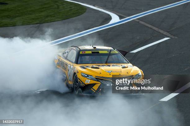 Christopher Bell, driver of the DeWalt Toyota, celebrates with a burnout after winning the NASCAR Cup Series Bank of America Roval 400 at Charlotte...