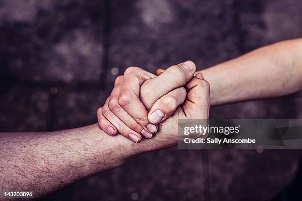 hands connected together - handen ineengevouwen stockfoto's en -beelden