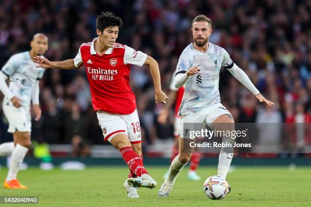Takehiro Tomiyasu of Arsenal and Jordan Henderson of Liverpool during the Premier League match at Emirates Stadium on October 09, 2022 in London,...