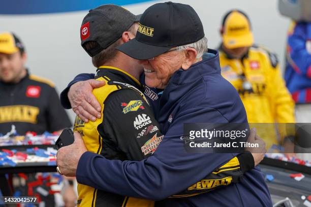 Christopher Bell, driver of the DeWalt Toyota, is embraced by JGR team owner and Hall of Famer Joe Gibbs in victory lane after winning the NASCAR Cup...