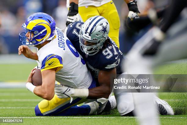 Matthew Stafford of the Los Angeles Rams is sacked by Osa Odighizuwa of the Dallas Cowboys during the fourth quarter at SoFi Stadium on October 09,...