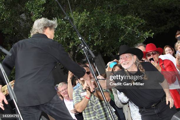 Singer Kris Kristofferson shakes Willie Nelson's hand during the unveiling of Willie's statue at ACL Live on April 20, 2012 in Austin, Texas.