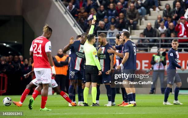 Referee Pierre Gaillouste gives a yellow card to Sergio Ramos of PSG during the Ligue 1 match between Stade de Reims and Paris Saint-Germain at Stade...