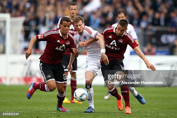 Robert Mak of Nuernberg and his team mate Timothy Chandler battle for the ball with Marcell Jansen of Hamburg during the Bundesliga match between...
