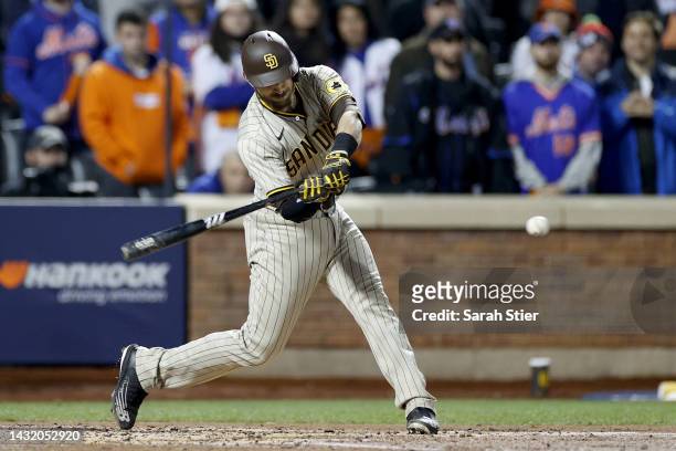Austin Nola of the San Diego Padres hits a two RBI single to score Josh Bell and Ha-Seong Kim against Chris Bassitt of the New York Mets during the...