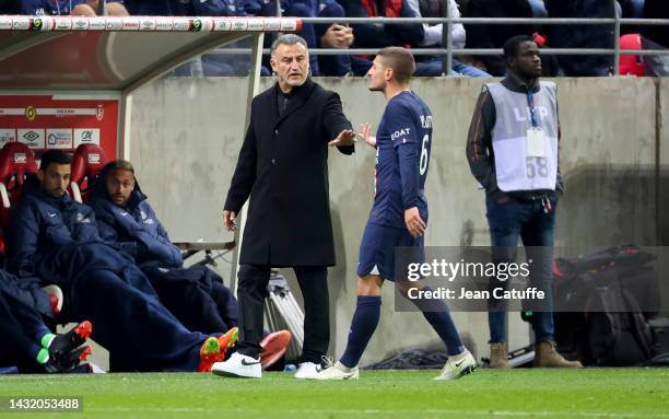 Coach of PSG Christophe Galtier tries to calm down Marco Verratti of PSG during the Ligue 1 match between Stade de Reims and Paris Saint-Germain at...