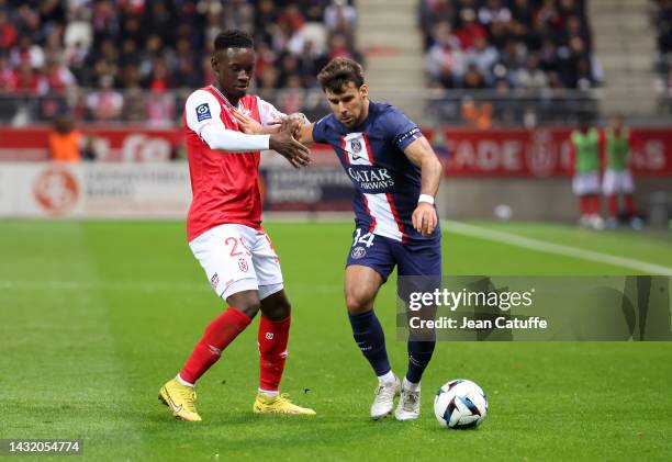 Juan Bernat of PSG, Folarin Balogun of Reims during the Ligue 1 match between Stade de Reims and Paris Saint-Germain at Stade Auguste Delaune on...