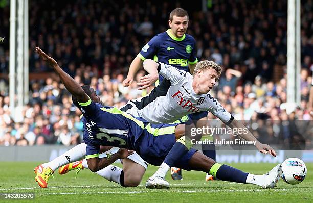 Pavel Pogrebnyak of Fulham is tackled by Maynor Figueroa of Wigan Athletic during the Barclays Premier League match between Fulham and Wigan Athletic...