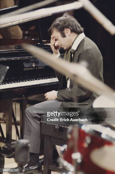 American pianist, conductor, and composer Andre Previn at the piano, circa 1965.