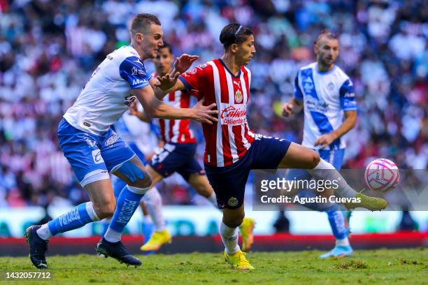 Angel Zaldivar of Chivas fights for the ball with Lucas Jaques of Puebla during the playoff match between Puebla and Chivas as part of the Torneo...