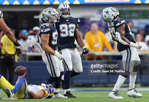Dorance Armstrong , Leighton Vander Esch and Osa Odighizuwa of the Dallas Cowboys react after sacking Matthew Stafford of the Los Angeles Rams during...