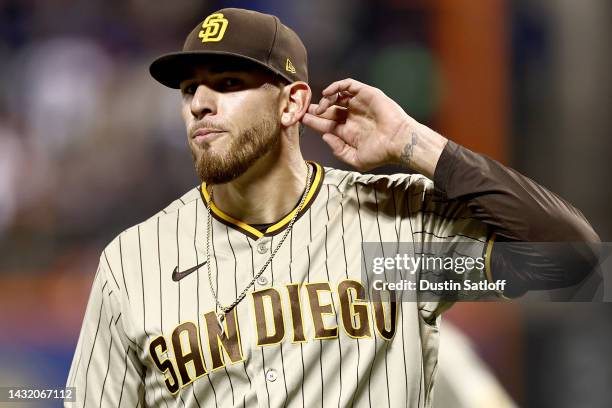 Joe Musgrove of the San Diego Padres gestures to his ear as he walks back to the dugout after closing out the sixth inning against the New York Mets...