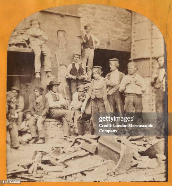 Stereoscopic image of workers gathered around the cupola furnace in the viaduct works, during the construction of the Crumlin Viaduct in South Wales,...