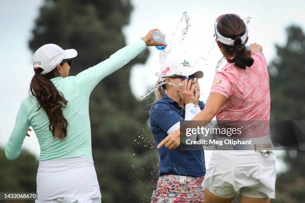 Paula Reto of South Africa and Andrea Lee of the United States splash Jodi Ewart Shadoff of England with water on the 18th green after she won the...