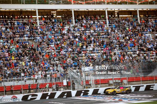 Christopher Bell, driver of the DeWalt Toyota, takes the checkered flag to win the NASCAR Cup Series Bank of America Roval 400 at Charlotte Motor...