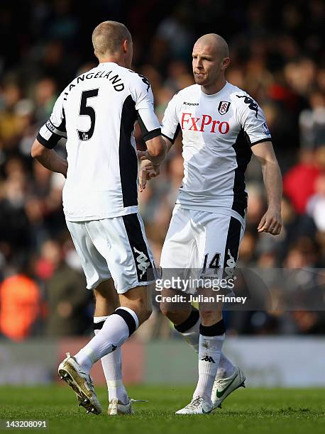 Brede Hangeland of Fulham congratulates team mate Philippe Senderos after his winning goal bring victory in the Barclays Premier League match between...