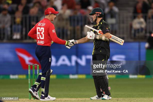 Jos Buttler of England shakes hands with Mitchell Swepson of Australia after winning game one of the T20 International series between Australia and...
