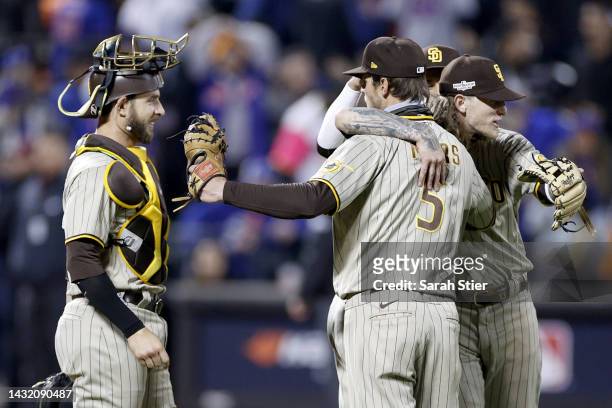 Josh Hader of the San Diego Padres celebrates with Austin Nola, Wil Myers and and Manny Machado after defeating the New York Mets in game three to...