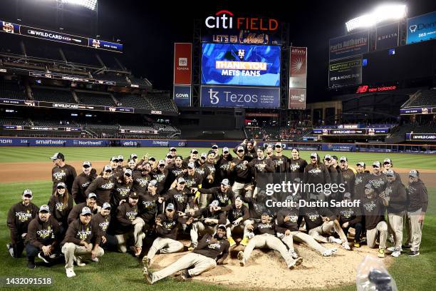 The San Diego Padres pose on the field after defeating the New York Mets in game three to win the National League Wild Card Series at Citi Field on...