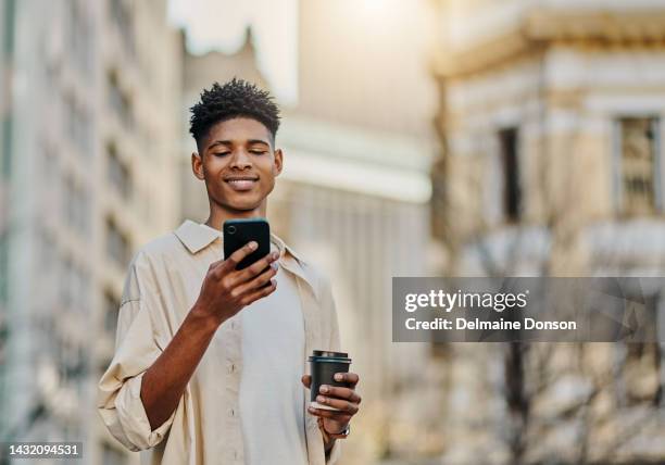 black man and social media on smartphone with coffee in city for weekend leisure in new york. young, happy and attractive african male with positive smile for mobile notification on break. - new media imagens e fotografias de stock