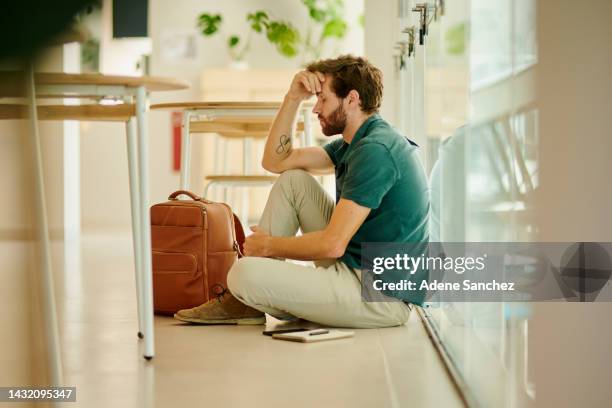 anxiety, depression and stress student with burnout, sad and thinking about exam, university and debt at campus. mental health, education and depressed man sitting on the floor at college or school - job search stress stock pictures, royalty-free photos & images