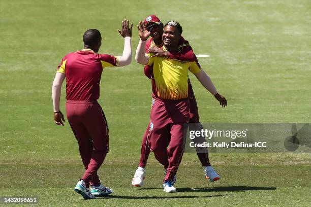 Evin Lewis of the West Indies celebrates with team mates during the ICC 2022 Men's T20 World Cup Warm Up Match between West Indies and United Arab...