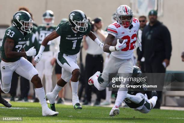 TreVeyon Henderson of the Ohio State Buckeyes plays against the Michigan State Spartans at Spartan Stadium on October 08, 2022 in East Lansing,...