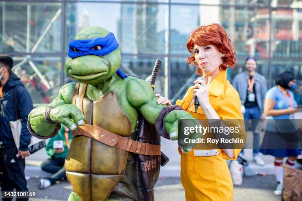Leonardo and April O'Neil cosplayers from "Teenage Mutant Ninja Turtles" pose during New York Comic Con 2022 on October 09, 2022 in New York City.