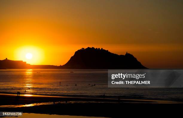 the sun sets in zarautz, san sebastian spain - san sebastian spain stock pictures, royalty-free photos & images