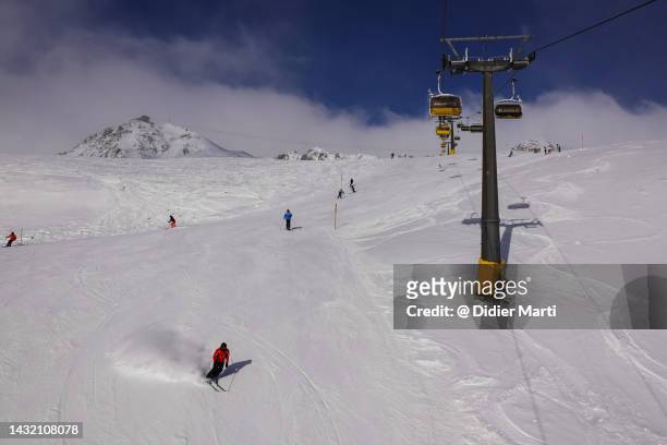 skier in st moritz ski resort in the swiss alps in canton graubunden on a sunny winter day - st moritz stock-fotos und bilder