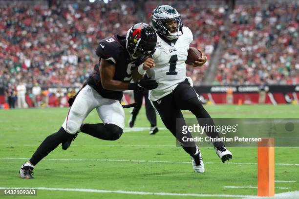 Quarterback Jalen Hurts of the Philadelphia Eagles is knocked out of bounds by linebacker Isaiah Simmons of the Arizona Cardinals during the first...