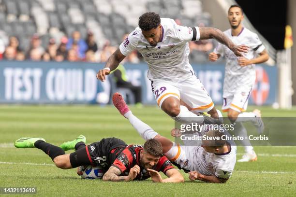 Brandon Borrello of the Wanderers is tackled by Perth Glory's Darryl Lachman and Jack Clisby during round one A-League Men's match between Western...