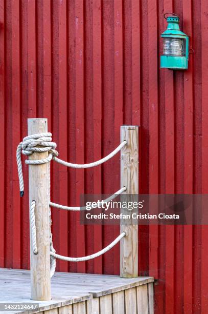 green oil lamp on a rorbuer fishing home, lofoten islands, norway - fishing hut stock pictures, royalty-free photos & images