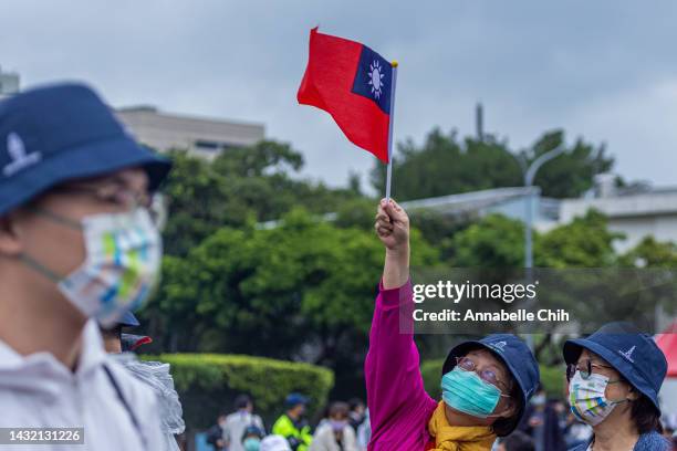 Woman holds a Taiwanese flag on the Taiwan's National Day on October 10, 2022 in Taipei, Taiwan. Taiwan playing a significant role in global supply...