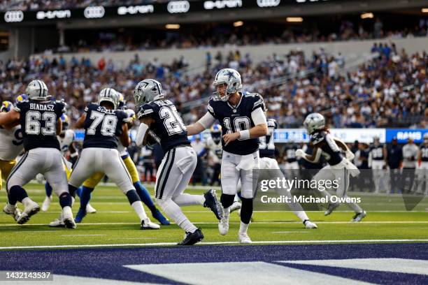 Cooper Rush of the Dallas Cowboys hands off to Tony Pollard of the Dallas Cowboys during an NFL football game between the Los Angeles Rams and the...