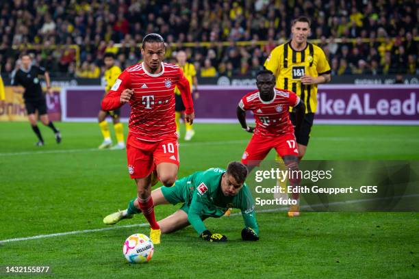 Alexander Meyer of Borussia Dortmund is challenged by Leroy Sane of Bayern during the Bundesliga match between Borussia Dortmund and FC Bayern...