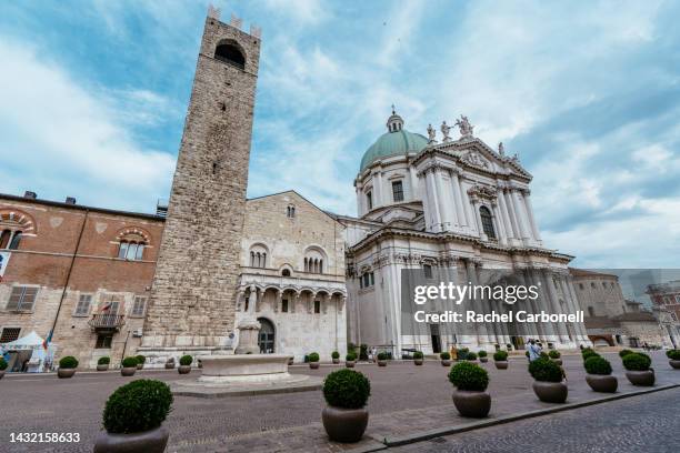 tourist taking photos of new cathedral of santa maria assunta and tower of pégol in "piazza paolo vi" square. - brescia stock-fotos und bilder