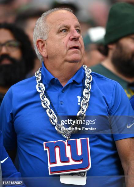 New York Giants fan with a big chain and NY logo looks on during the NFL match between New York Giants and Green Bay Packers at Tottenham Hotspur...