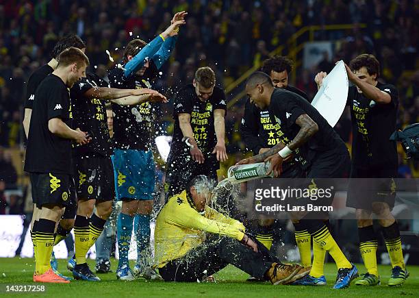 Felipe Santana of Dortmund and his team mates give Norbert Dickel a beer shower after the Bundesliga match between Borussia Dortmund and Borussia...