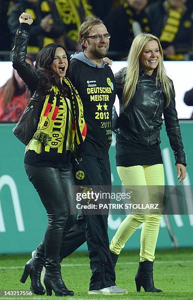 Dortmund's head coach Juergen Klopp celebrates with his wife Ulla and Dortmund's manager's wife Jola Zorc after the German first division Bundesliga...