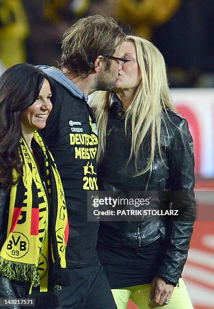 Dortmund's head coach Juergen Klopp kisses his wife Ulla while celebrating with Dortmund's manager's wife Jola Zorc after the German first division...