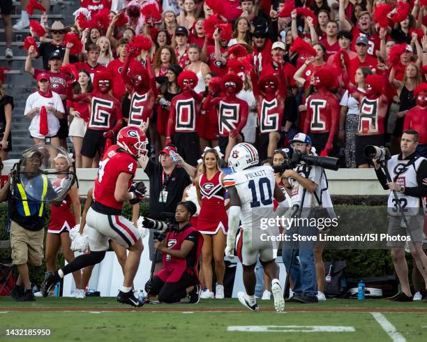 Oscar Delp of the Georgia Bulldogs runs after a catch and is confronted by Zion Puckett of the Auburn Tigers during a game between Auburn Tigers and...